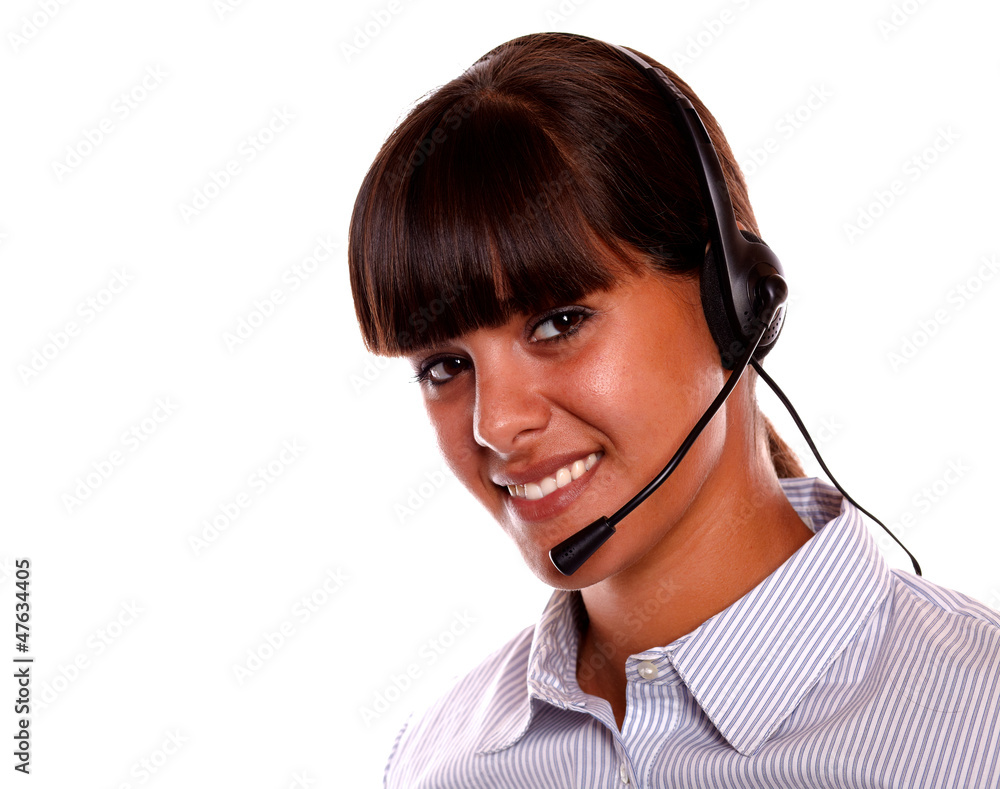 Smiling secretary using earphone looking at you Smiling secretary using earphone looking at you