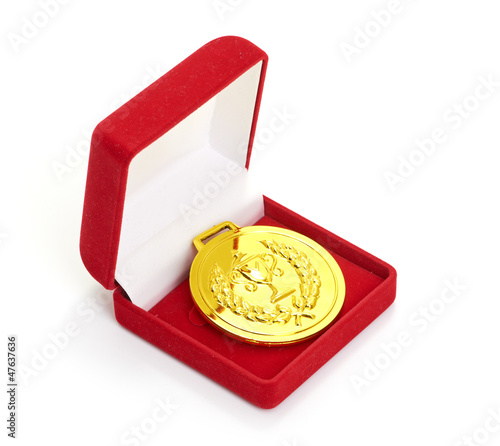 Golden medal in red gift box. isolated on white background photo