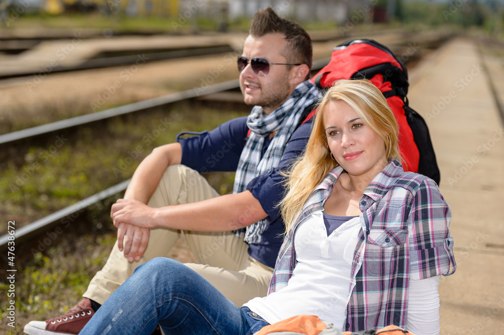 Couple backpack traveling resting on railroad trip Couple backpack traveling resting on railroad trip