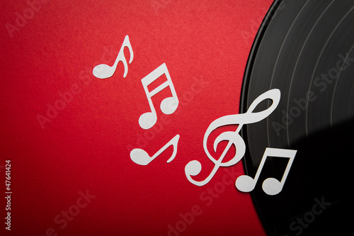 Paper cut of music note on Black vinyl record