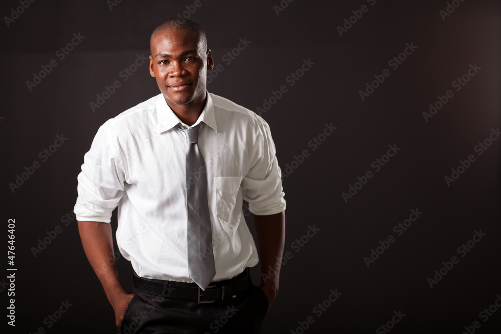 handsome young african american man on black background