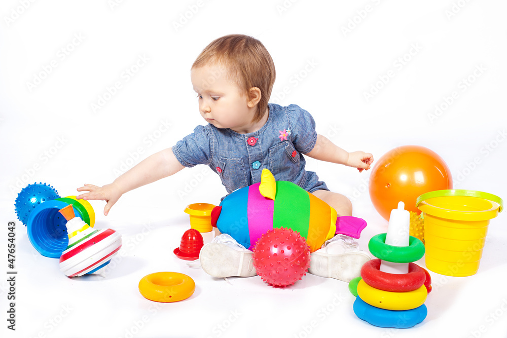 Small child plays with toys. Studio shoot. Isolated Small child plays with toys. Studio shoot. Isolated