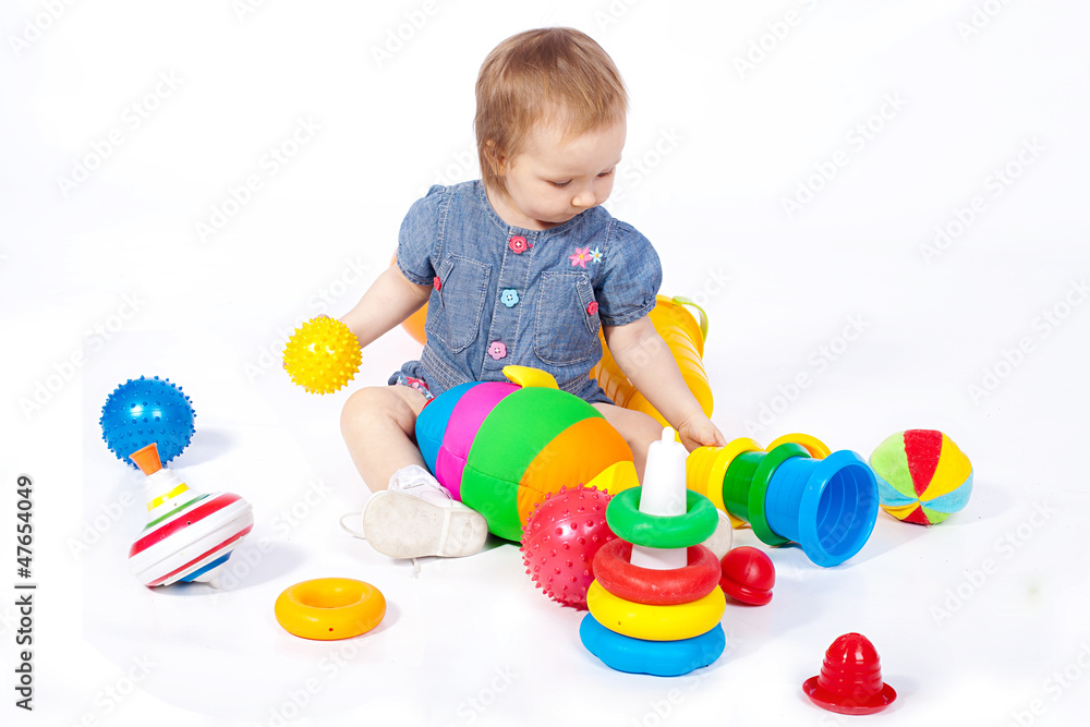 Small child plays with toys. Studio shoot. Isolated Small child plays with toys. Studio shoot. Isolated