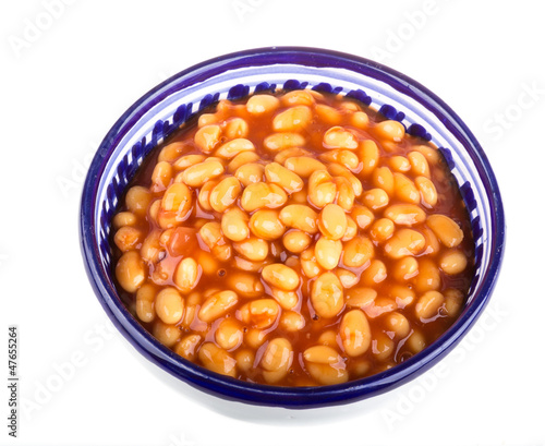 Marinated haricot beans in tomato sauce with shallots on a plate