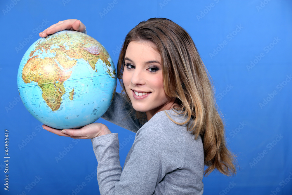 Attractive young woman holding a globe Attractive young woman holding a globe