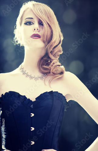 Cuadro en lienzo Fashion women in corset. Photo with backlight.