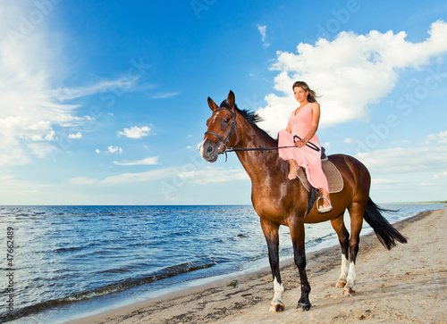 girl with horse on seacoast