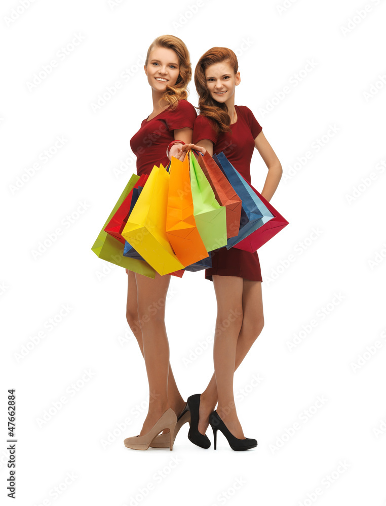 teenage girls in red dresses with shopping bags