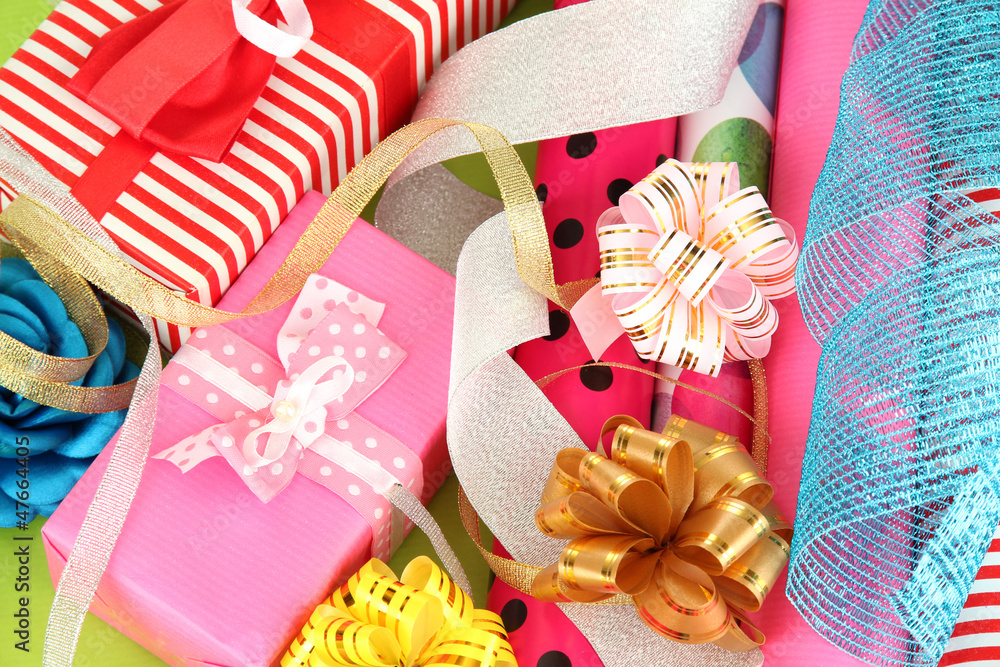 Rolls of Christmas wrapping paper with ribbons, bows