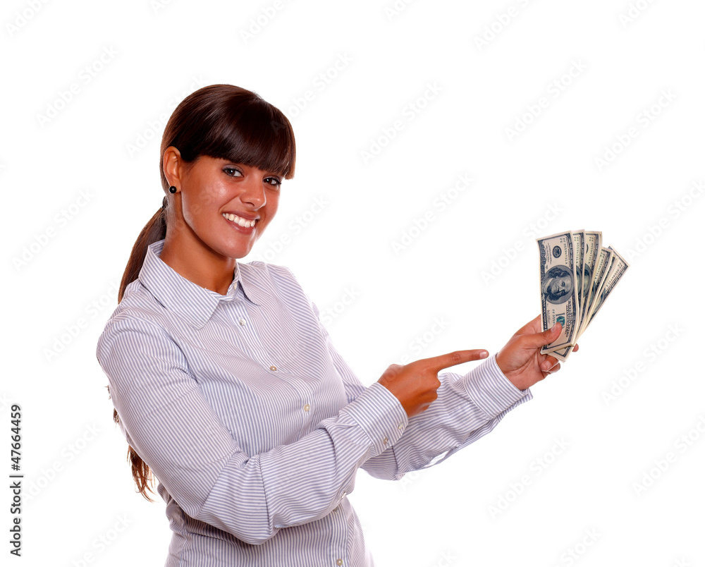 Smiling young woman pointing holding cash money