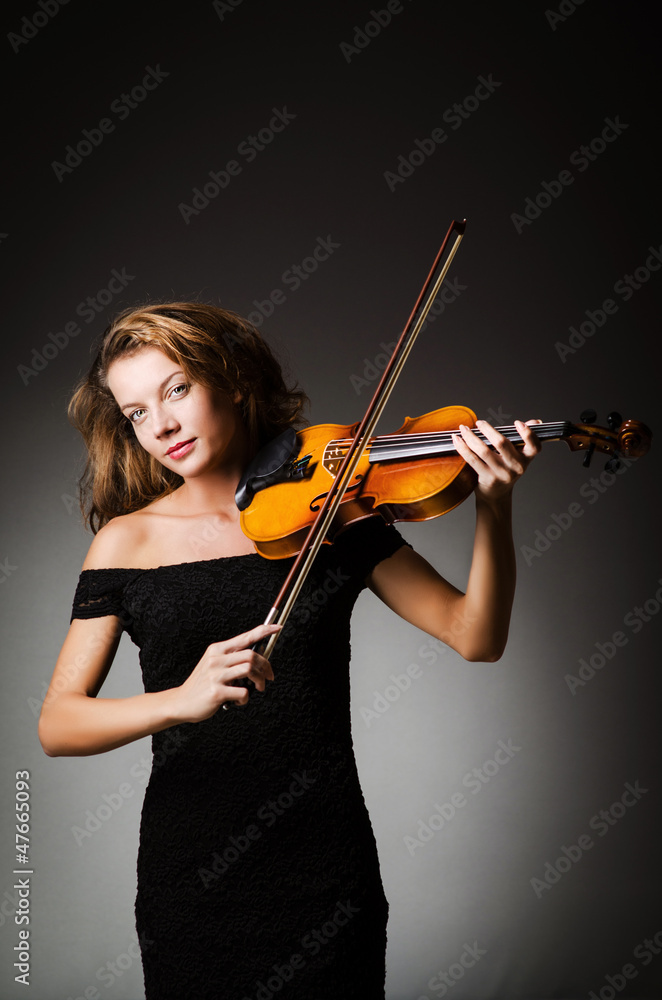 Woman performer with violin in studio Woman performer with violin in studio