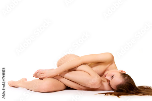 Photography Beautiful young nude woman lying on white