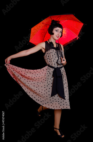 Canvas Print woman in retro styled dress with red umbrella