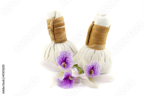 herbal compress with orchid flower on white background