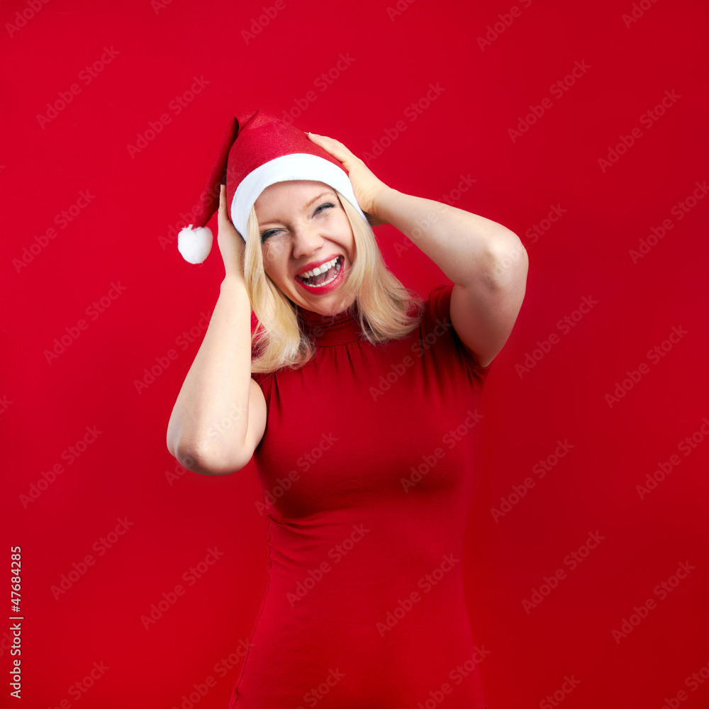 pretty blonde woman wearing a christmas hat having fun pretty blonde woman wearing a christmas hat having fun