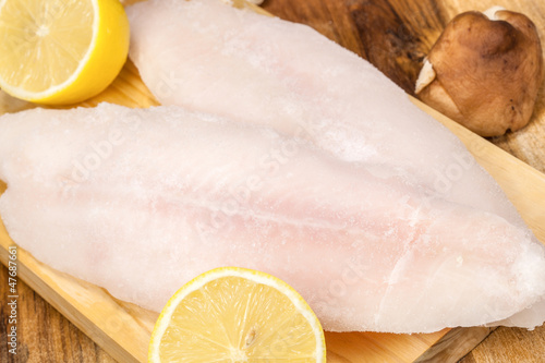 Delicious raw fish fillet with lemon. Culinary seafood eating photo