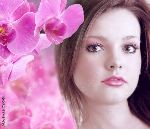 beautiful young woman with pink orchids