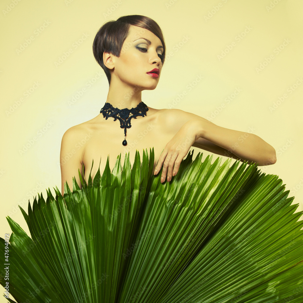 Fototapeta premium Beautiful lady with palm leaves