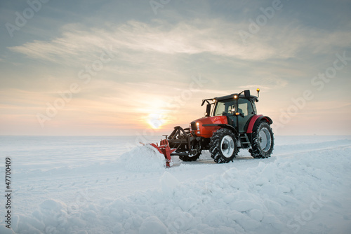 Tractor cleaning snow