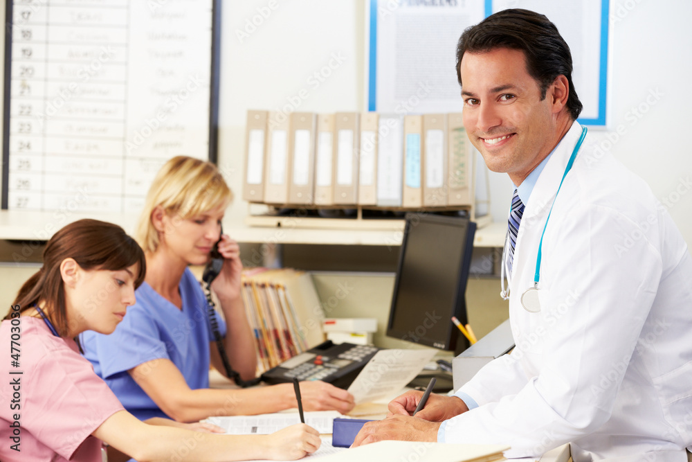 Doctor With Two Nurses Working At Nurses Station Doctor With Two Nurses Working At Nurses Station