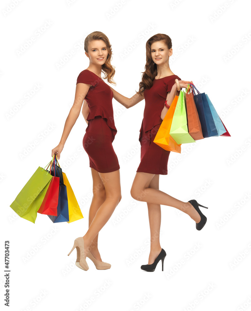 teenage girls in red dresses with shopping bags
