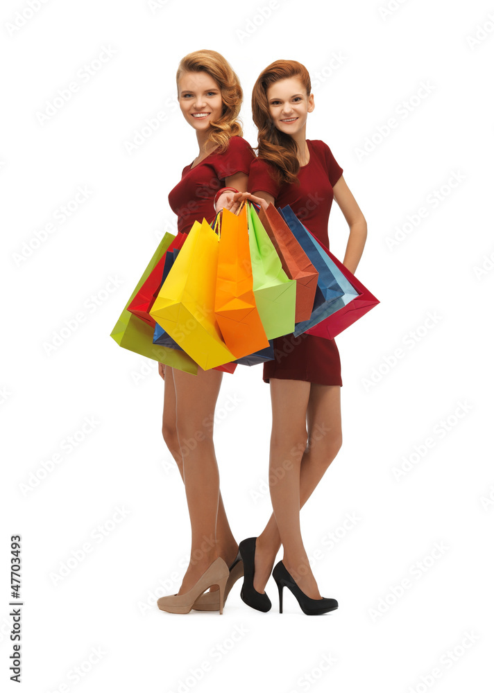 teenage girls in red dresses with shopping bags teenage girls in red dresses with shopping bags