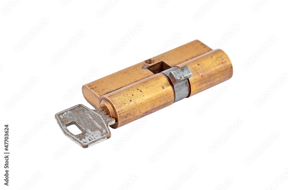 Door lock cylinder core with key, isolated on white background