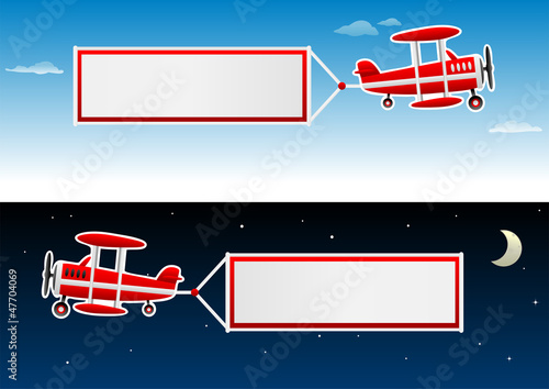 biplane with banners in the sky