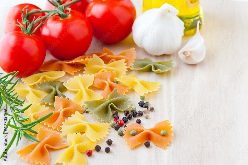 Ingredients for Italian cuisine: farfalle pasta, tomatoes, olive Ingredients for Italian cuisine: farfalle pasta, tomatoes, olive