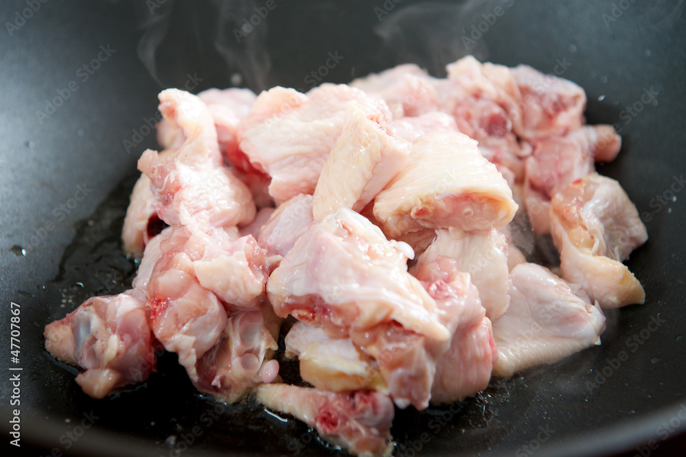 Raw Chicken wings cooking