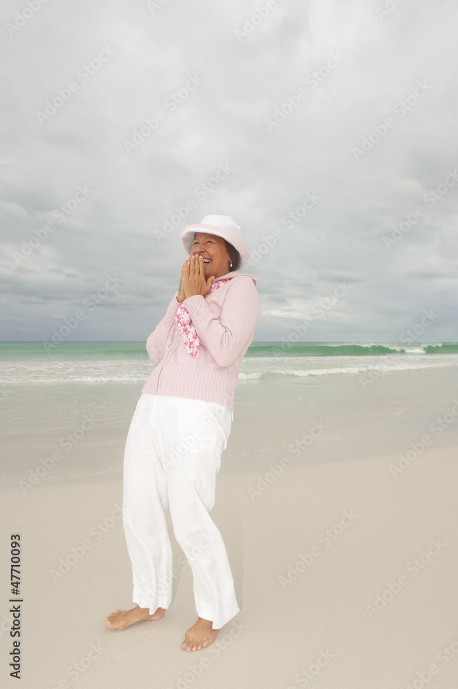 Mature woman active retirement storm beach isolated Mature woman active retirement storm beach isolated