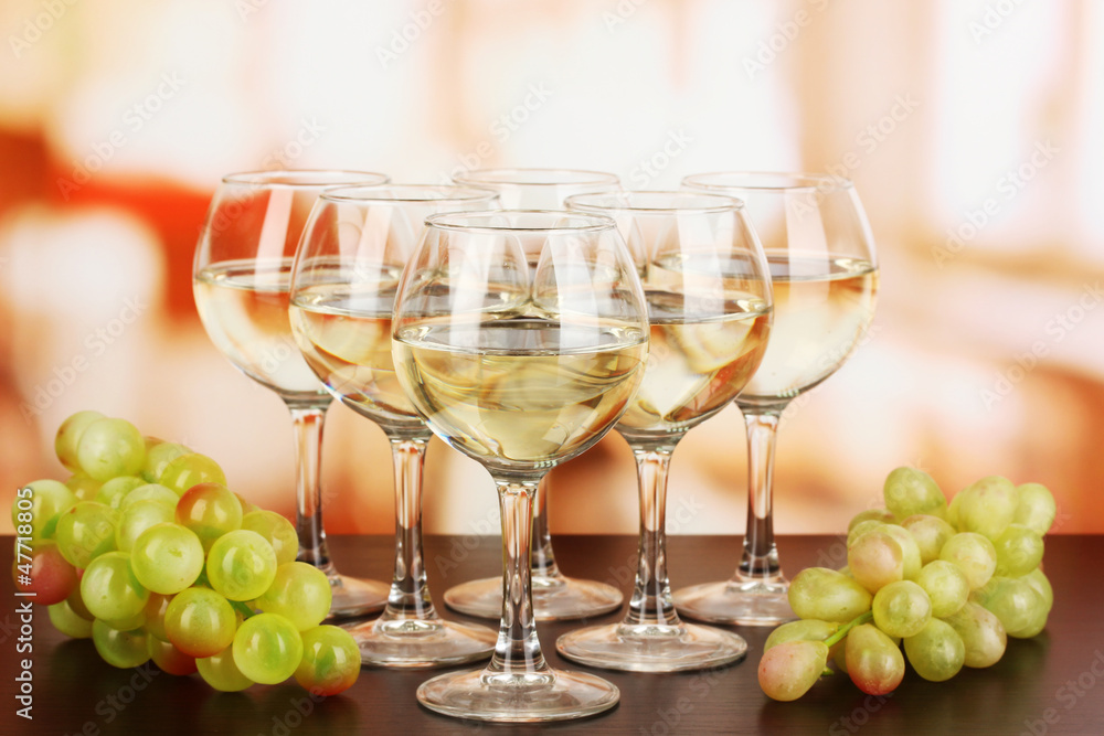 White wine in glass on room background White wine in glass on room background