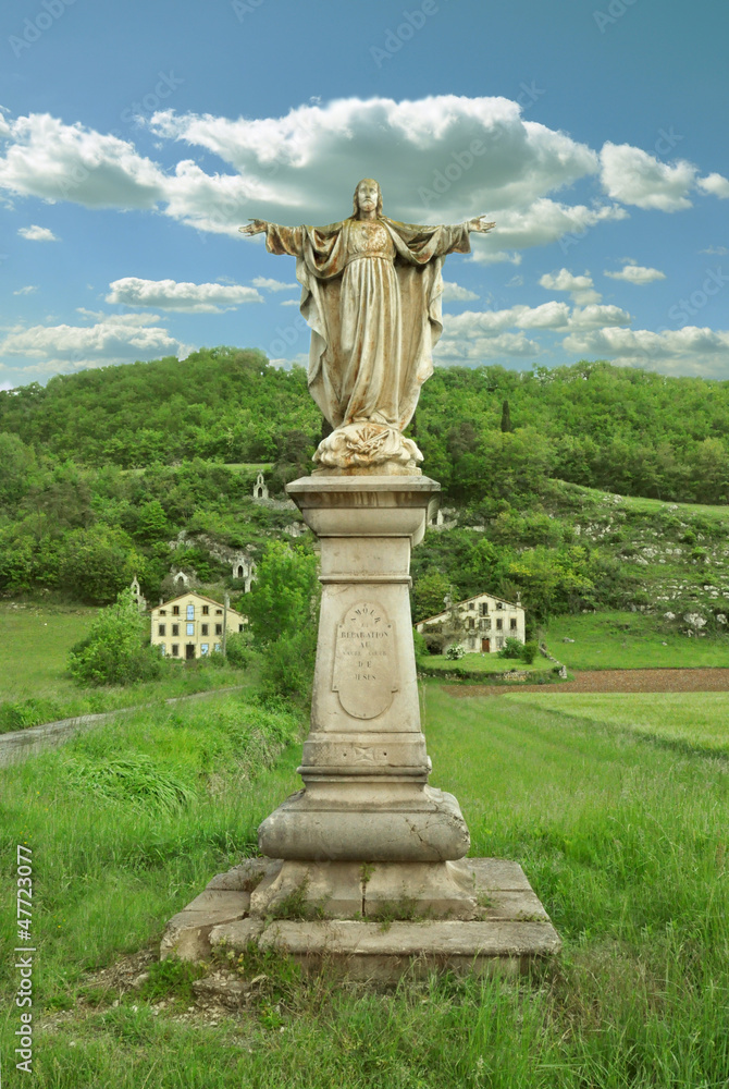 statue of jesus in rural landscape