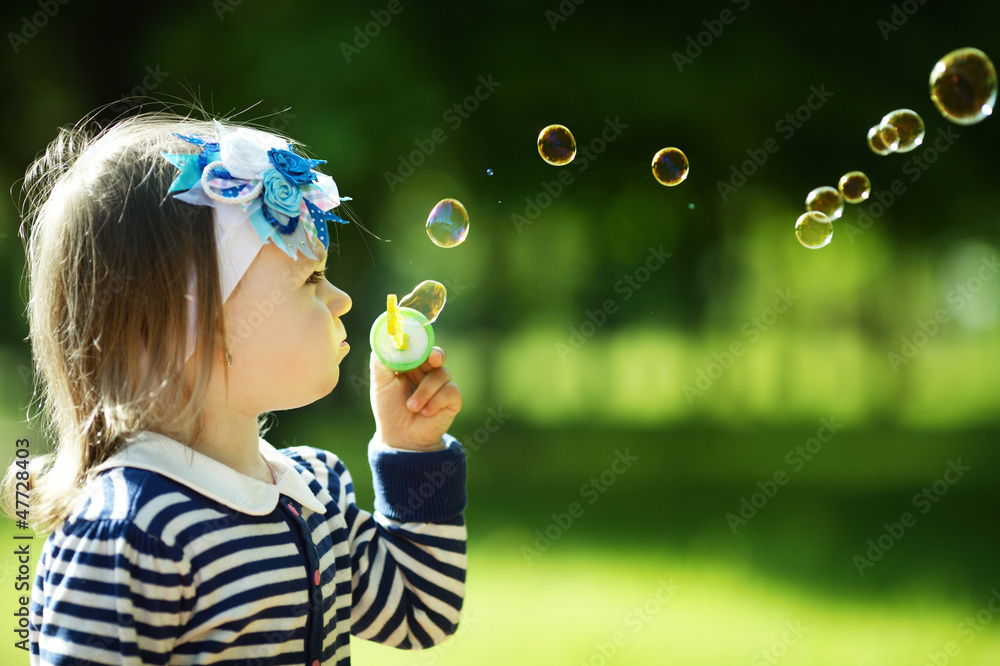 little funny girl plays with bubbles
