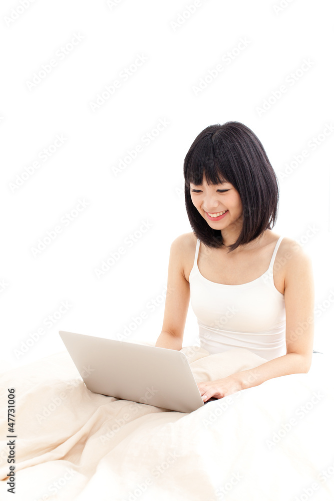 attractive asian woman using laptop in the bed attractive asian woman using laptop in the bed