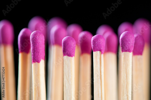 Rows of new lilac matchsticks over black background