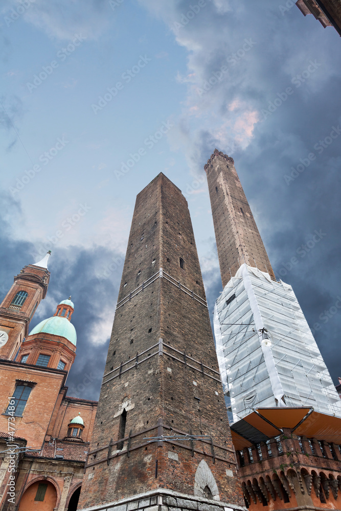 Fototapeta Two towers - symbol of city under dramatic sky in Bologna, Italy