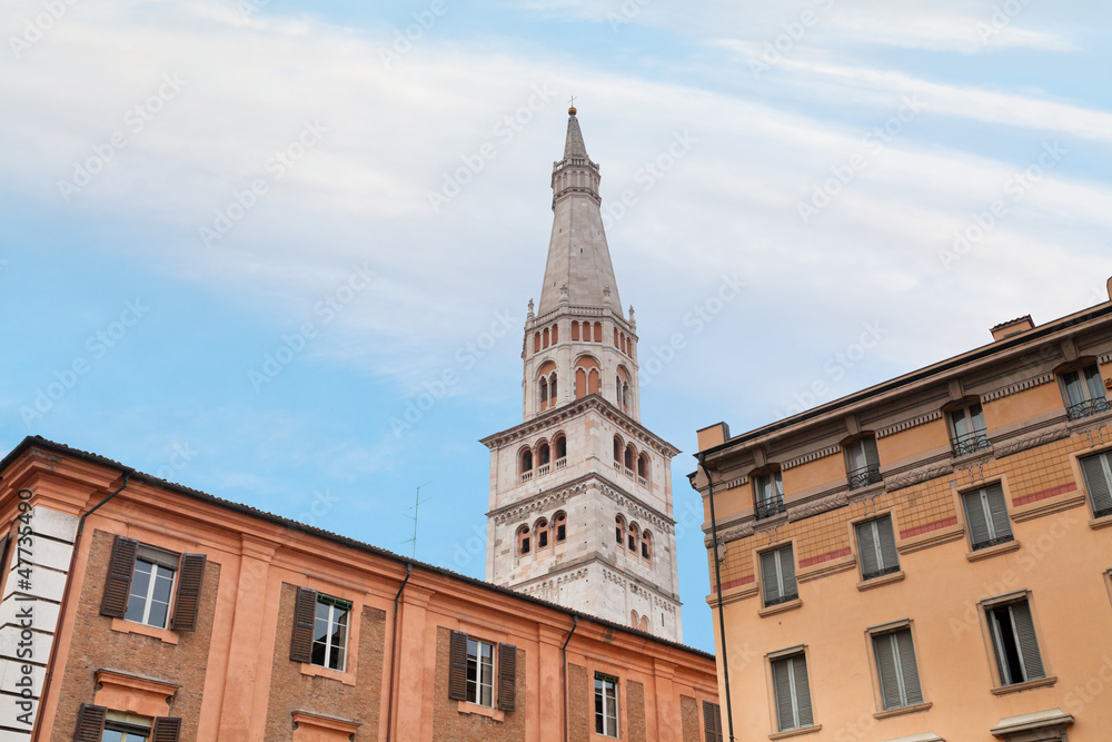 bell tower of Modena Cathedral under urban houses