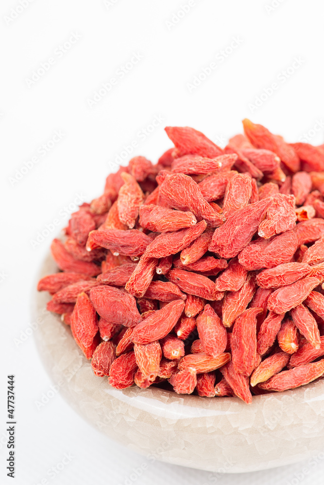 dried wolfberry fruit in bowl on white background dried wolfberry fruit in bowl on white background