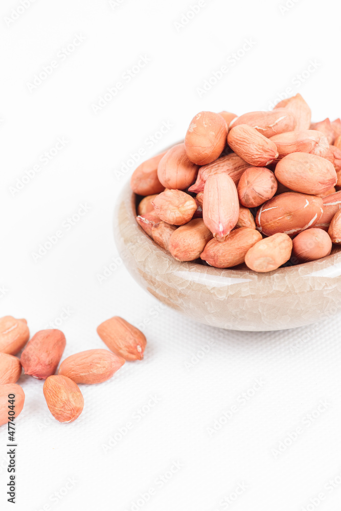 Peanuts in bowl on white Peanuts in bowl on white