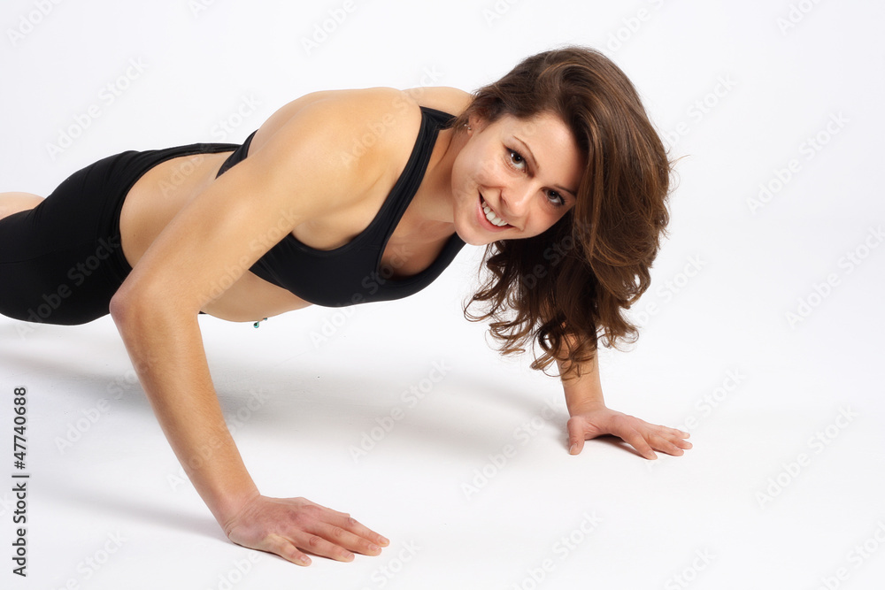 Portrait of a healthy woman fitness push-up exercises