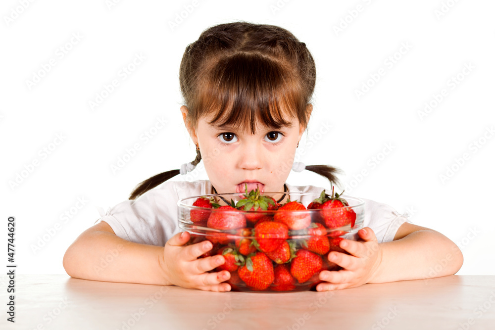 A child with a bowl fresh strawberries A child with a bowl fresh strawberries