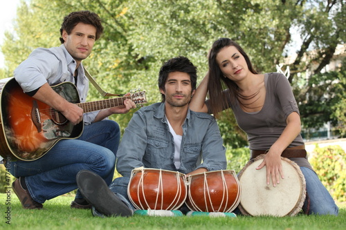 three musicians in a park