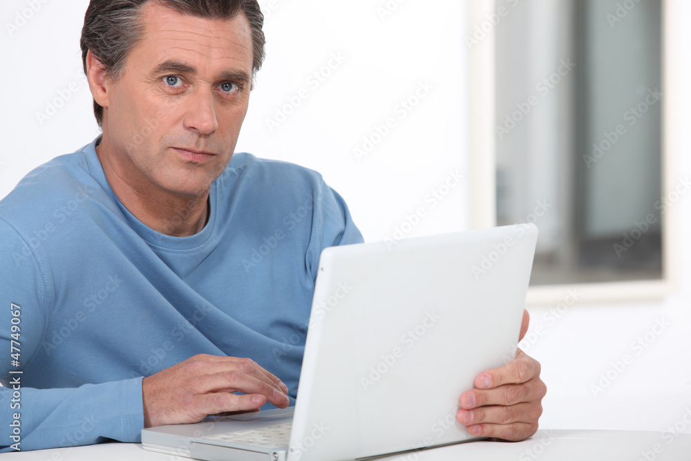 Man using a laptop computer Man using a laptop computer