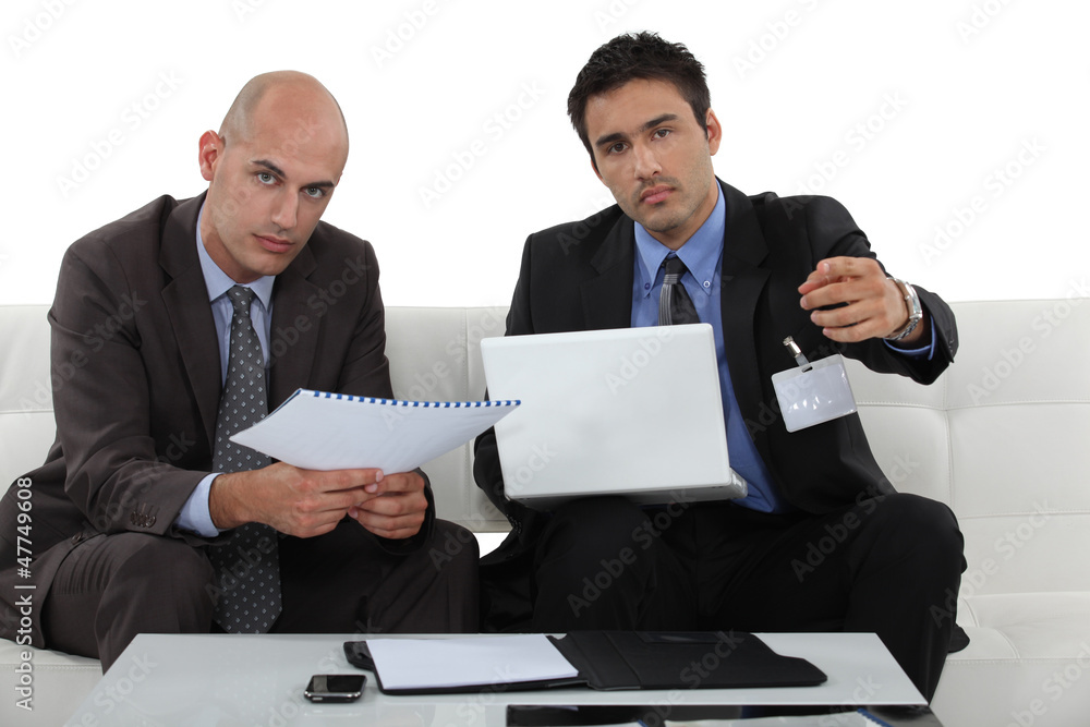 Businessmen with a laptop on a sofa Businessmen with a laptop on a sofa