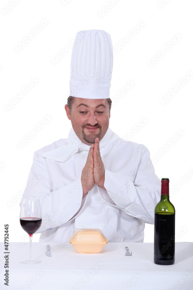 chef sitting between glass of wine and facing hamburger chef sitting between glass of wine and facing hamburger