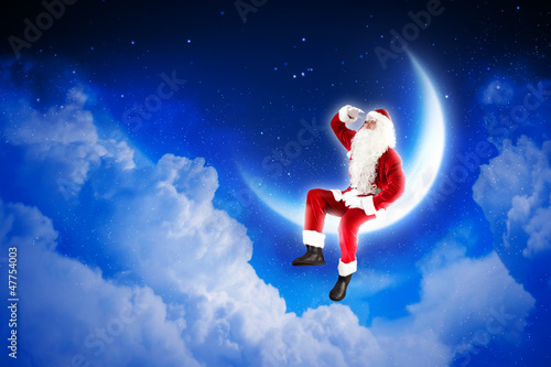 photo of santa claus sitting on the moon