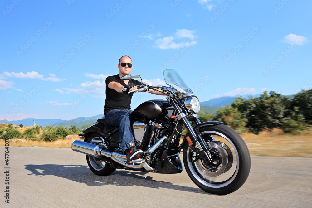 A young biker riding a customized motorcycle