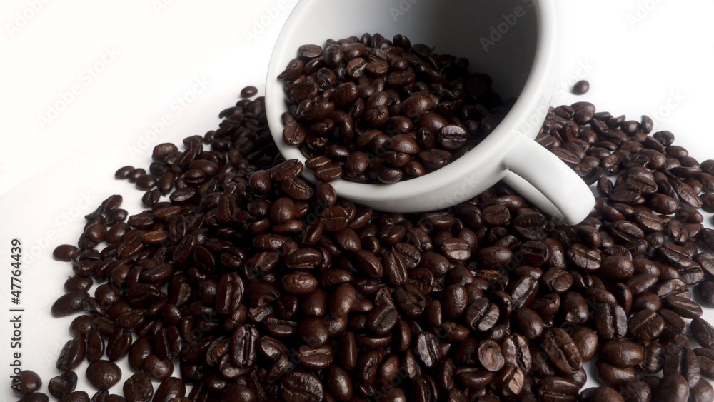 A white cup with beans coffee A white cup with beans coffee