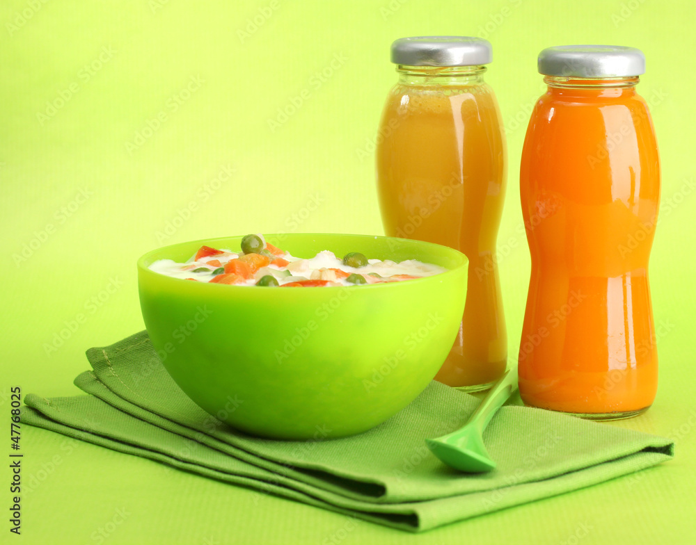 tasty dieting food and bottles of juice, on green background tasty dieting food and bottles of juice, on green background